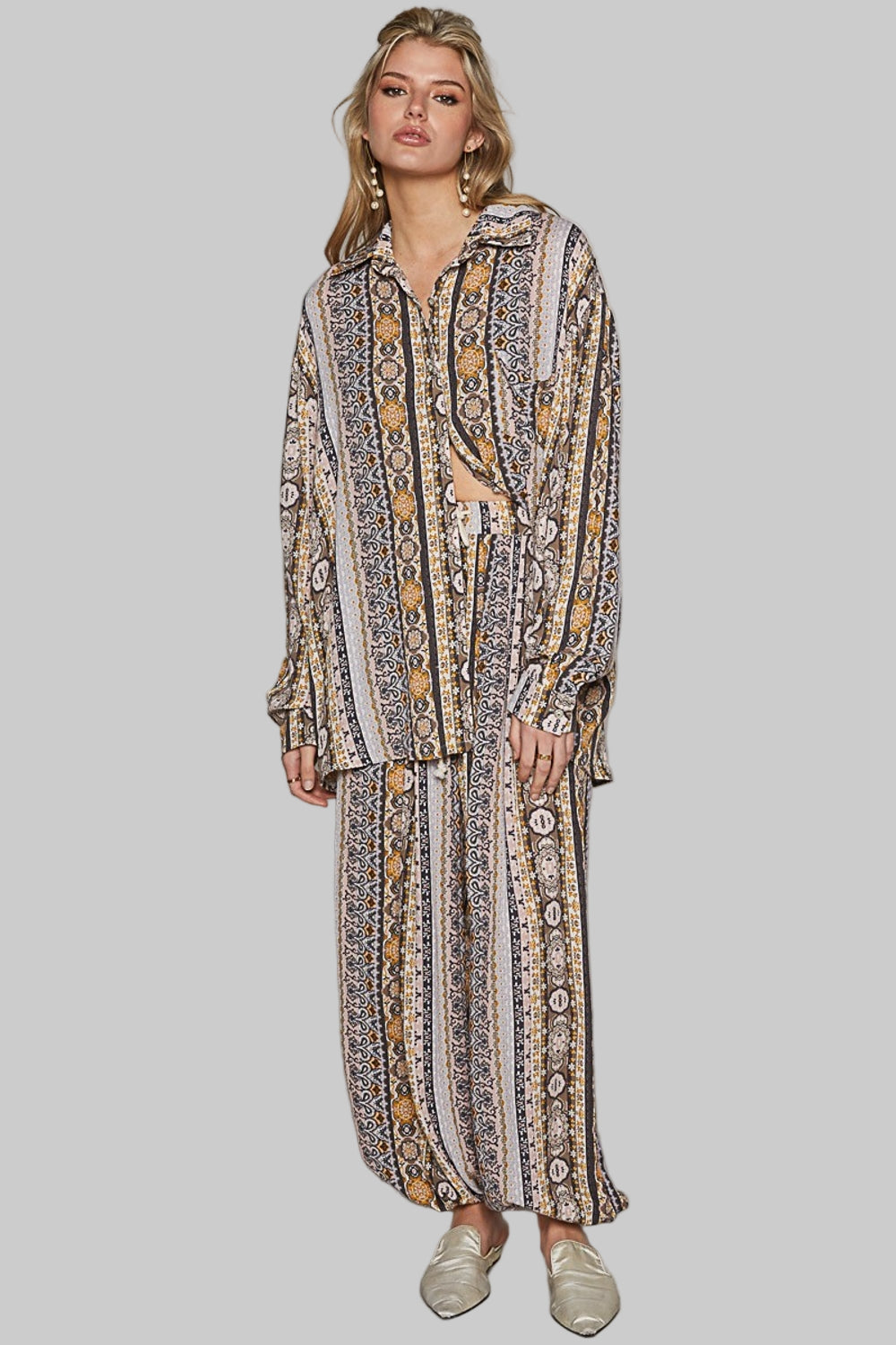 The Long Sleeve Button Down Printed Shirt is a versatile and trendy piece that adds a pop of personality to your wardrobe. Pair it with jeans for a casual daytime look.