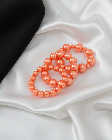 Elevate your everyday style with this stunning Orange Pearl 3-Piece Bracelet Set. Perfect for layering or wearing solo, these versatile bracelets add a pop of color and elegance to any outfit.