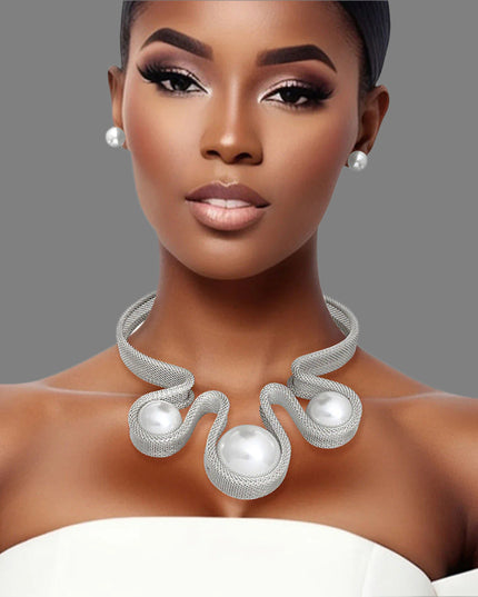 Women's Bib Necklace Set Bold Statement Rigid Chunky Silver Metal Mesh Chain Necklace Featuring Triple Teardrop Shaped White Pearl Bib Detail. Bib measures 3.25" x 5.5". Rigid Mesh Chain measures .85" wide. Lobster Clasp Closure. Includes Matching Pearl Ball Stud Post Backing Earrings.