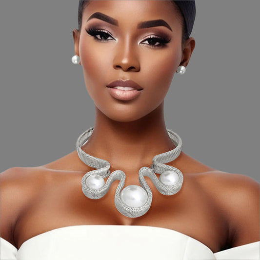 Women's Bib Necklace Set Bold Statement Rigid Chunky Silver Metal Mesh Chain Necklace Featuring Triple Teardrop Shaped White Pearl Bib Detail. Bib measures 3.25" x 5.5". Rigid Mesh Chain measures .85" wide. Lobster Clasp Closure. Includes Matching Pearl Ball Stud Post Backing Earrings.