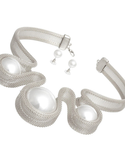 Women's Bib Necklace Set Bold Statement Rigid Chunky Silver Metal Mesh Chain Necklace Featuring Triple Teardrop Shaped White Pearl Bib Detail. Bib measures 3.25" x 5.5". Rigid Mesh Chain measures .85" wide. Lobster Clasp Closure. Includes Matching Pearl Ball Stud Post Backing Earrings.