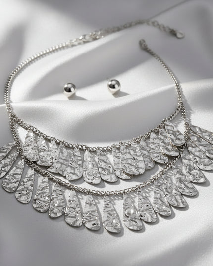 Women's Bib Necklace Set. Modern Edgy Boho-Chic Silver Metal Curb Chain Necklace Featuring Tiered Bib with Hammered Metal Organic Teardrop Dangle Details.