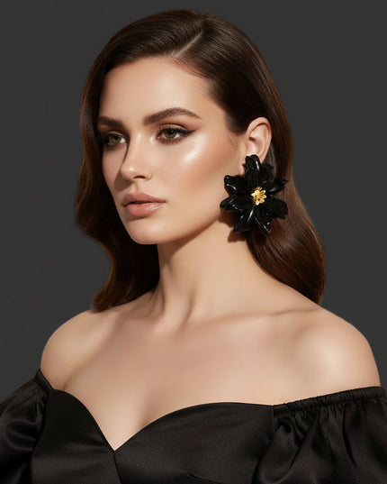 Women's Stud Earrings. Floral Statement Oversized Stud Earrings Featuring Large Dimensional Wavy Acrylic Petals in Bold Black with an Orange and Yellow Beaded Center. Bold and Eye-Catching Floral Playful Elegance. Earrings Measure 4.25 inches and 2.25 inches Tall. Post Backing.