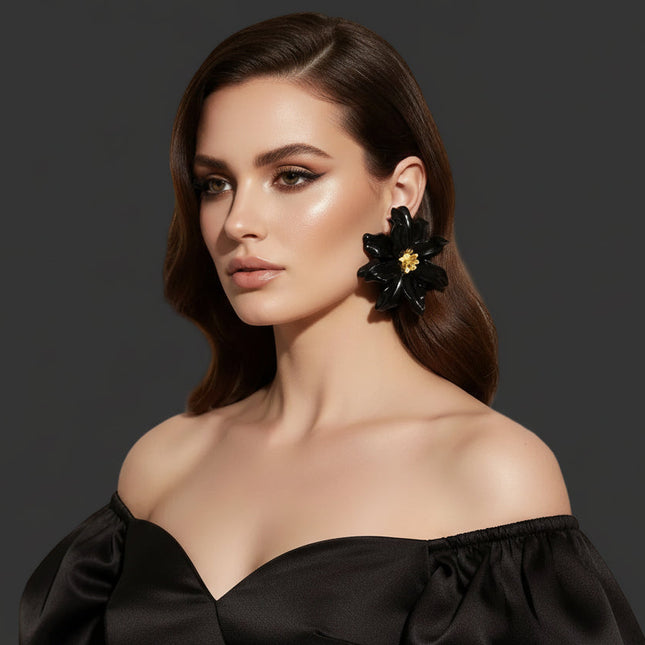 Women's Stud Earrings. Floral Statement Oversized Stud Earrings Featuring Large Dimensional Wavy Acrylic Petals in Bold Black with an Orange and Yellow Beaded Center. Bold and Eye-Catching Floral Playful Elegance. Earrings Measure 4.25 inches and 2.25 inches Tall. Post Backing.