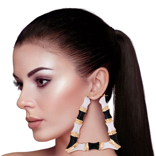 Gold Metal with Black and White Epoxy Hollow Trapezoid Bamboo Hoop Earrings. Earrings measure 3.5 inches wide
