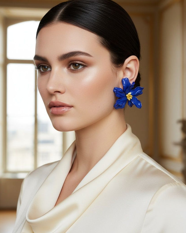 Women's Stud Earrings. Floral Statement Oversized Stud Earrings Featuring Large Dimensional Wavy Acrylic Petals in Vibrant Blue with an Orange and Yellow Beaded Center. Bold and Eye-Catching Floral Playful Elegance. 