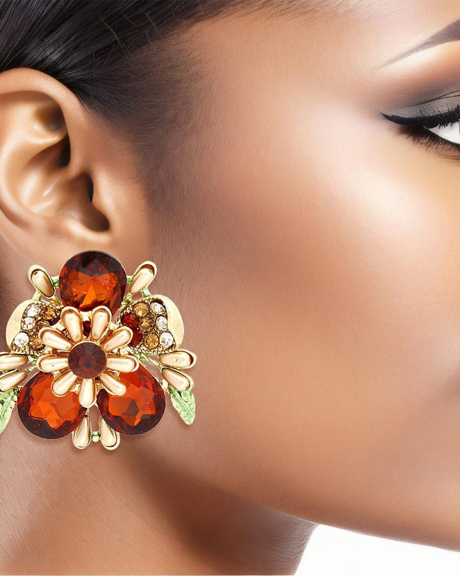 Women's Clip-On Earrings Gold Metal Flower Clip-Ons Featuring Red Teardrop Crystals, Rhinestones, Oblong Pearls, and Green Leaf Details. Paddle Back Clip-Ons.