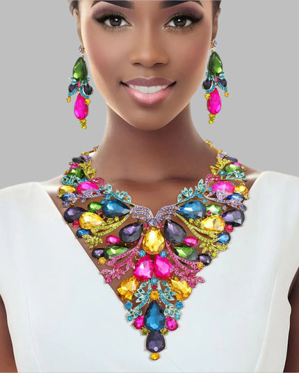 Women's Crystal Bib Necklace Set Gold Metal with Multicolor Teardrop Crystals and Rhinestones Jeweled Bib Statement Necklace. Formal Prom Wedding Set Features Elegant Leaf Filigree and Pointed Bib Design. Bib measures 5.75" x 7.5". Lobster Clasp Closure. Includes Matching Dangle Crystal Earrings