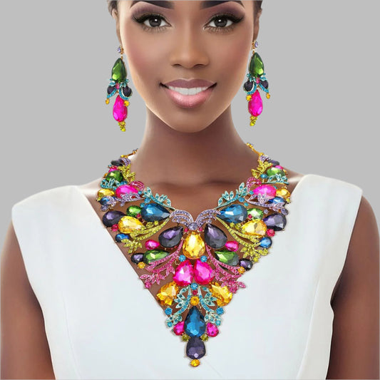 Women's Crystal Bib Necklace Set Gold Metal with Multicolor Teardrop Crystals and Rhinestones Jeweled Bib Statement Necklace. Formal Prom Wedding Set Features Elegant Leaf Filigree and Pointed Bib Design. Bib measures 5.75" x 7.5". Lobster Clasp Closure. Includes Matching Dangle Crystal Earrings