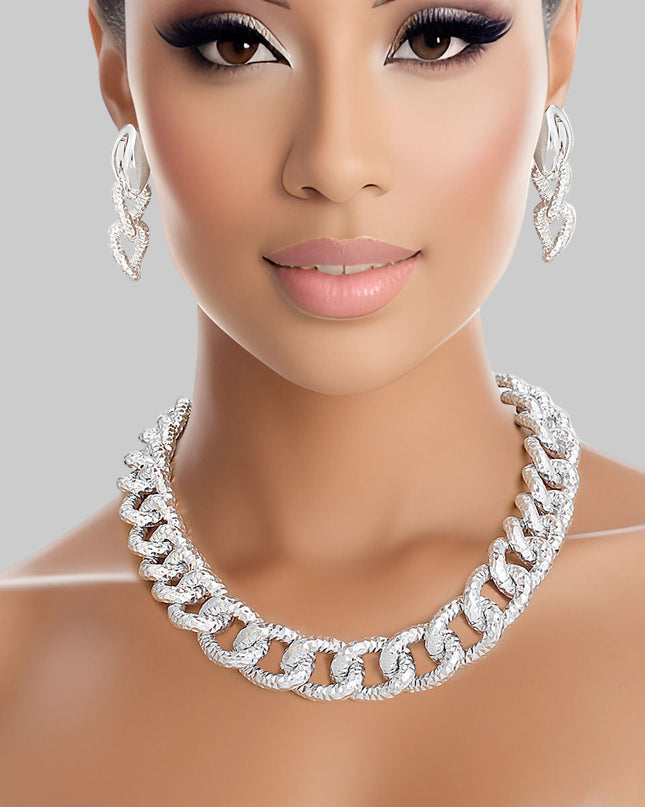 Women's Chain Necklace Set Shiny Oversized Silver Diamond Cut Textured Link Chain Necklace. Each Link measures 1" x .75". Silver Metal Lobster Clasp Closure. Includes Duo Texture Matching Chain Link Drop Post Earrings. Earrings measure 2.5" x .75".