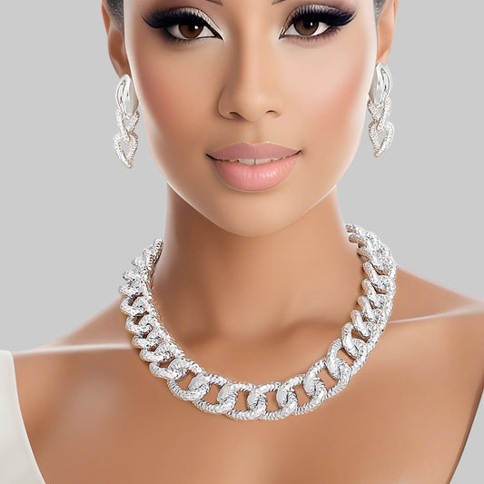 Women's Chain Necklace Set Shiny Oversized Silver Diamond Cut Textured Link Chain Necklace. Each Link measures 1" x .75". Silver Metal Lobster Clasp Closure. Includes Duo Texture Matching Chain Link Drop Post Earrings. Earrings measure 2.5" x .75".