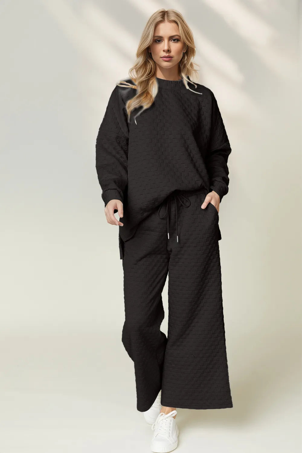 Black checkered slit high-low round neck top and wide leg pants set.