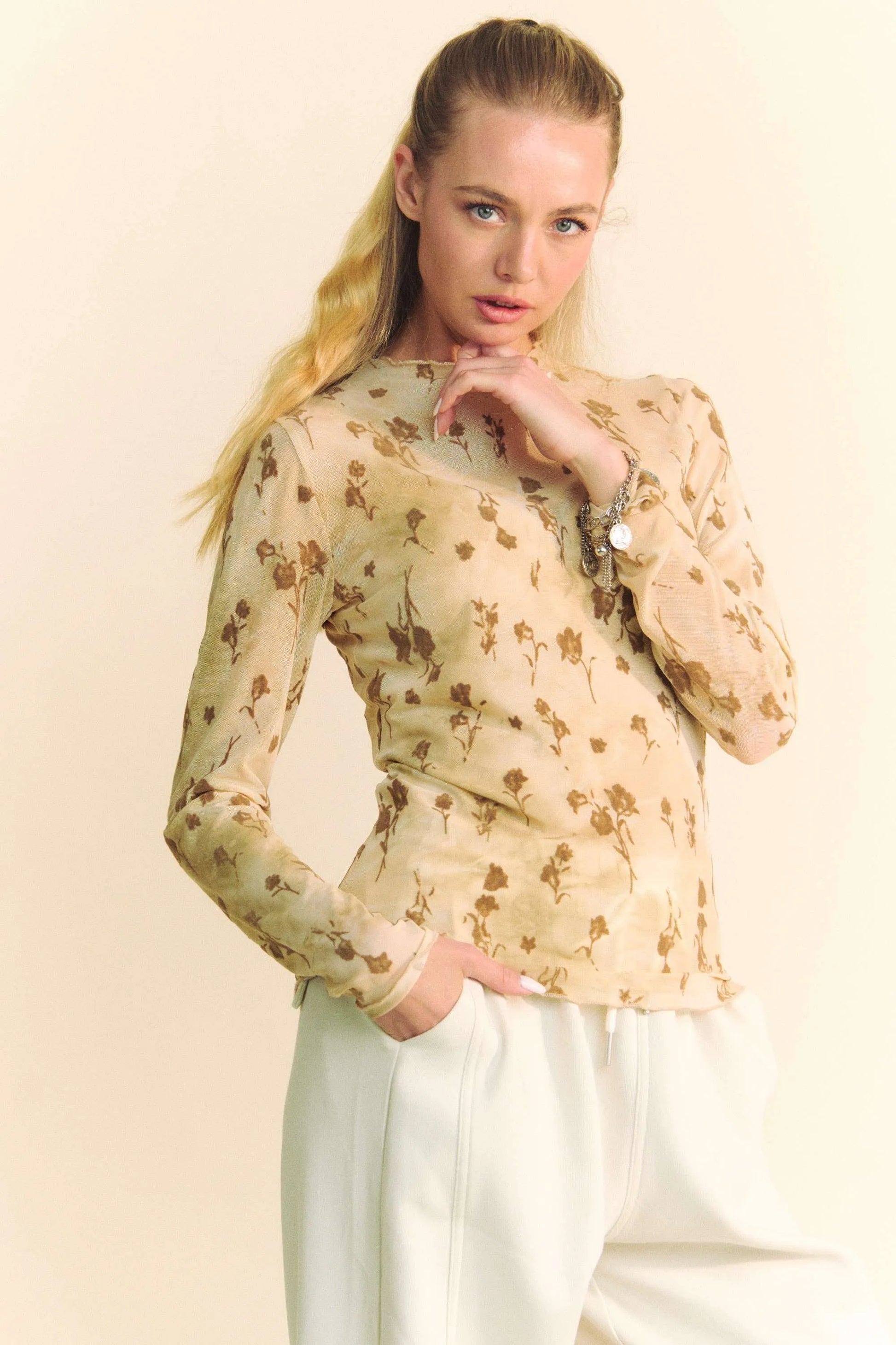 This elegant chiffon blouse features a romantic floral print on a light beige background. Made from high-quality, lightweight chiffon material that offers both comfort and style.