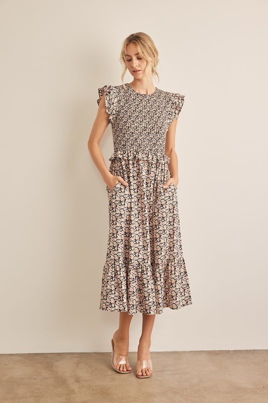 The Floral Smocked Ruffled Midi Dress is a feminine and elegant choice for any occasion. 