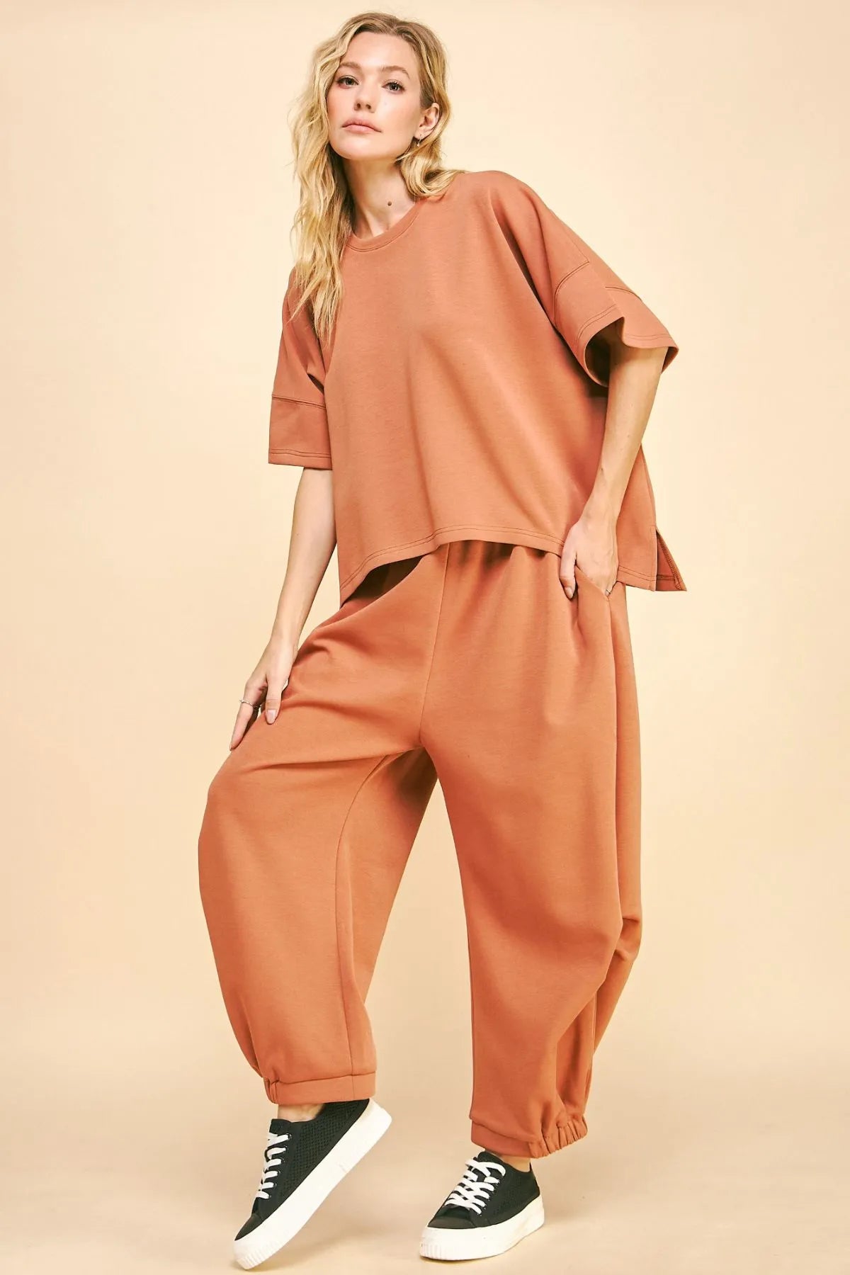 This set features a flowy top and elastic-waistband pants for a comfortable, stylish ensemble. The flowy top drapes beautifully, creating a flattering silhouette. The elastic waistband on the pants ensures a relaxed fit and ease of movement. Perfect for a casual day out or lounging at home, this set offers both comfort and style in one coordinated look