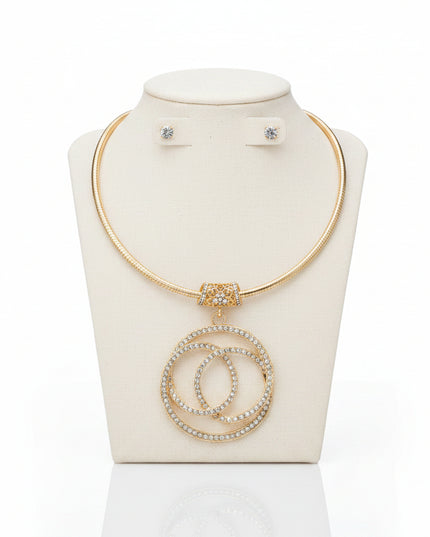 A sculptural 3D gold‑tone pendant suspended from a sleek 18‑inch chain, designed to sit at the collarbone for a refined, statement look.