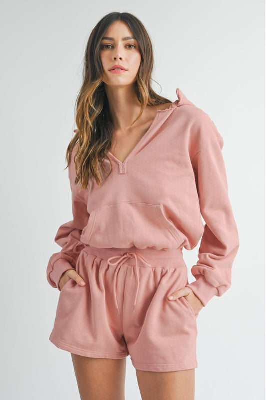 This French terry hooded romper offers a stylish, relaxed look with its long sleeves and deep V-neck. The loose fit provides comfort while the drawstring waist detailing adds a flattering silhouette. Perfect for a casual yet fashionable ensemble, this romper is versatile for a range of occasions. The cozy French terry fabric ensures a comfortable fit and feel. Elevate your loungewear with this trendy romper.
