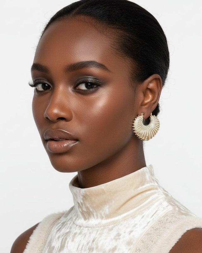 Women's Hoop Earrings. Maximum Sparkle Statement Earrings. Bold Gold Metal Chunky Croissant Shaped Hoop Earrings Featuring Aurora Borealis Rhinestone Stripe Detailing. Latch Closure.