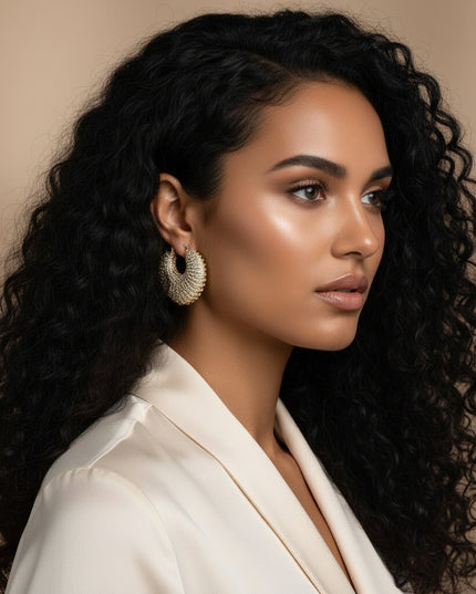 Women's Hoop Earrings. Maximum Sparkle Statement Earrings. Bold Gold Metal Chunky Croissant Shaped Hoop Earrings Featuring Aurora Borealis Rhinestone Stripe Detailing. Latch Closure.