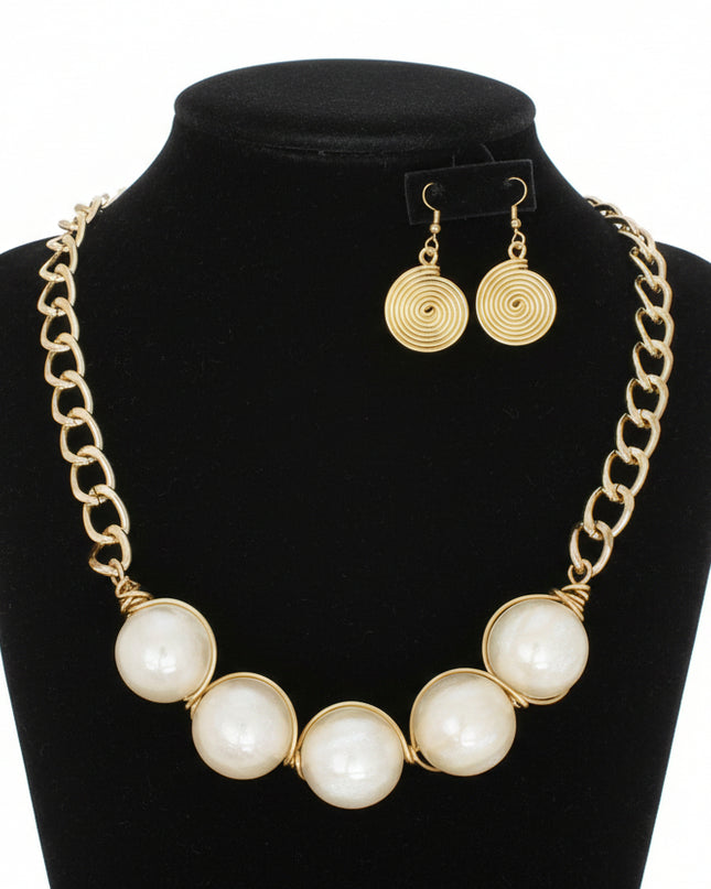 Women's Collar Necklace Set. Glossy and Galactic Chunky Gold Metal Chain Necklace with Eye-catching Centerpiece Collar Comprised of Jumbo Ivory Resin Ball Beads Featuring Swirled Glitter Inlay and Hand-wrapped Gold Metal Wire Detail. 