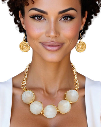 Women's Collar Necklace Set. Glossy and Galactic Chunky Gold Metal Chain Necklace with Eye-catching Centerpiece Collar Comprised of Jumbo Ivory Resin Ball Beads Featuring Swirled Glitter Inlay and Hand-wrapped Gold Metal Wire Detail. 