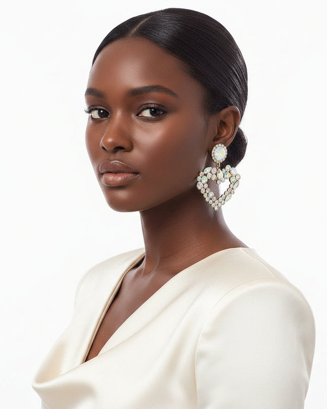 Each piece features a multi‑AURBO crystal heart, radiating a prism-like shimmer that shifts beautifully with movement. The stones sit in a sleek gold metal frame, creating a balance of softness and structure that feels both romantic and modern.