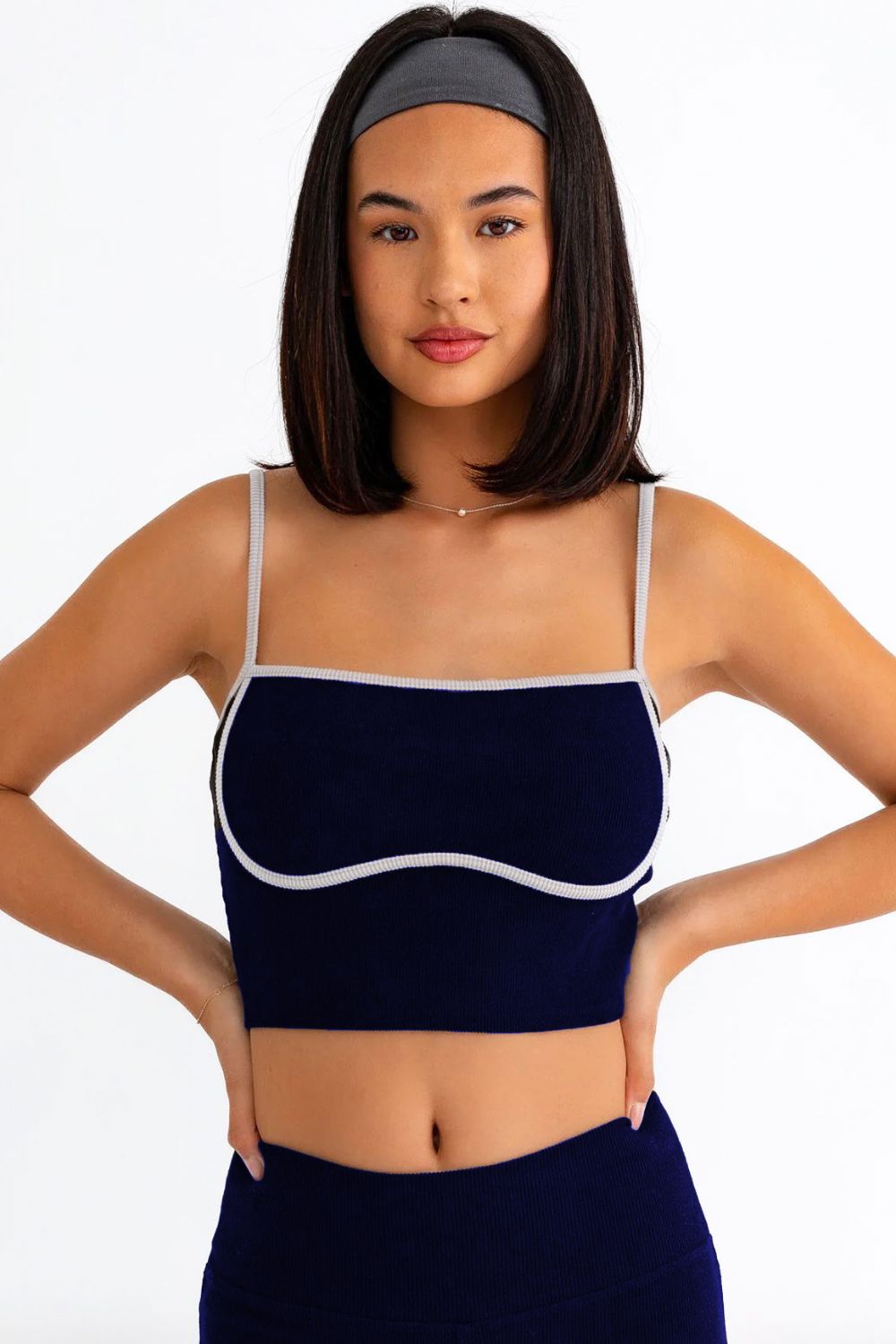 The Ribbed Crop Cami and High Waist Brushed Leggings set features a stylish design with contrast binding and spaghetti straps on the crop cami top. The ribbed texture adds a trendy touch to the ensemble, making it ideal for activewear. The crop length cami and high waist brushed leggings provide a snug and comfortable fit, perfect for workouts or yoga sessions. The stretchy and cool fabric ensures flexibility and breathability, making it the perfect attire for a workout or a comfy yet chic yoga look. 