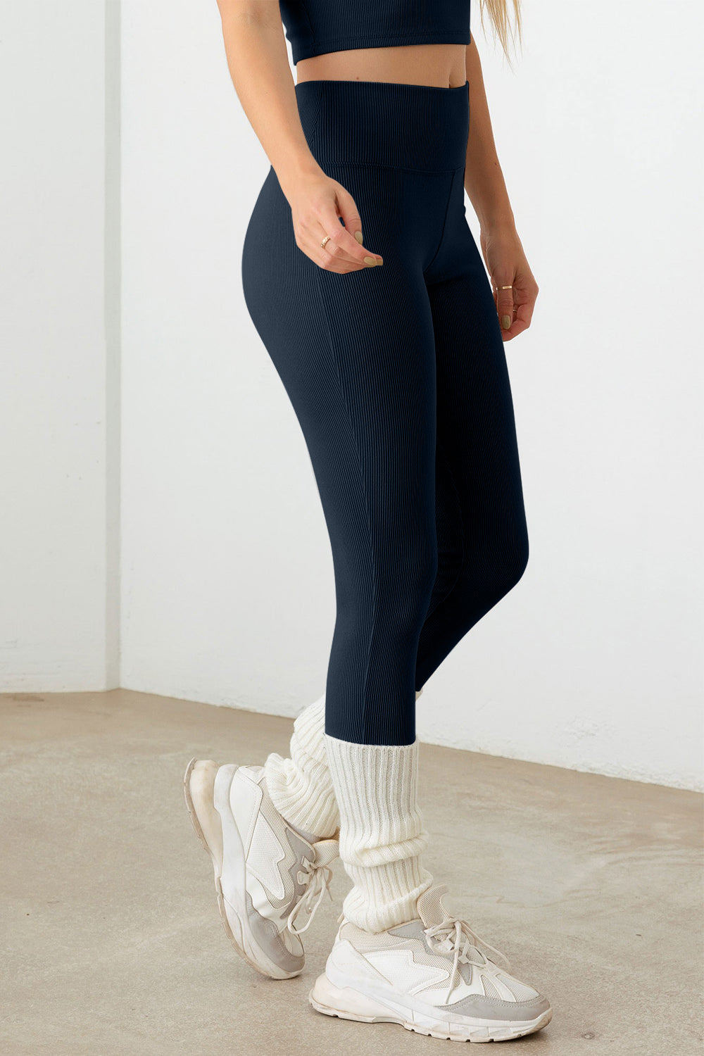 The Ribbed Crop Cami and High Waist Brushed Leggings set features a stylish design with contrast binding and spaghetti straps on the crop Cami top. The ribbed texture adds a trendy touch to the ensemble, making it ideal for activewear. The crop length Cami and high waist brushed leggings provide a snug and comfortable fit, perfect for workouts or yoga sessions. The stretchy and cool fabric ensures flexibility and breathability, making it the perfect attire for a workout or a comfy yet chic yoga look.