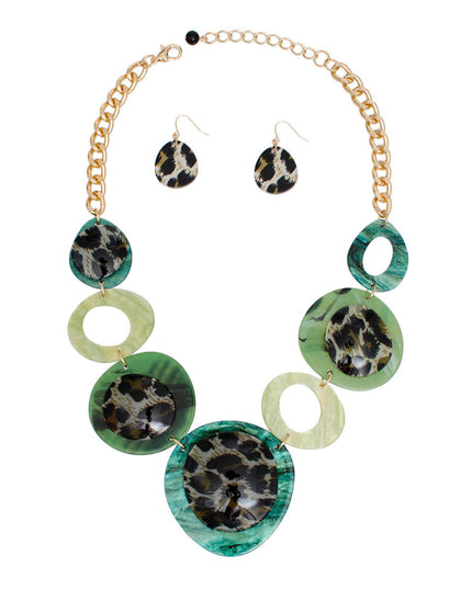 Women's Link Necklace Set Trending Marbled Shades of Green Acrylic with Glitter Linked Collar Design Featuring Rounded Leopard Print Acrylic Discs Details. Center Disc measures 2.75". Gold Metal Chain Lobster Clasp Closure. Includes Matching Fishhook Earrings.