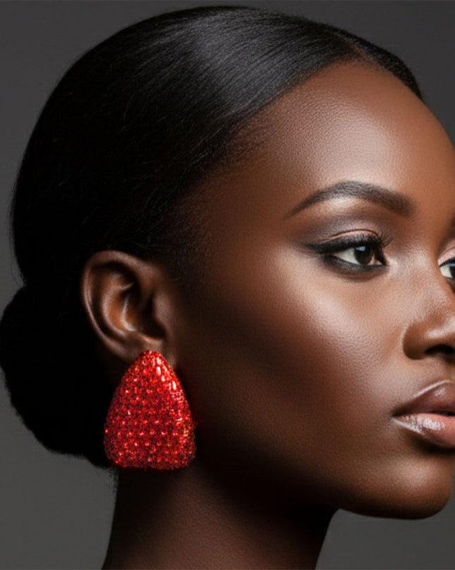 Women's Stud Earrings. Maximum Sparkle Statement Earrings. Bold Gold Metal Oversized Domed Teardrop Shaped Earrings Featuring Concave Center and Encrusted with Shimmering Red Baguette Crystals and Rhinestones.