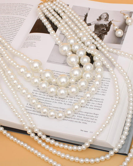 Women's Pearl Necklace Set 6 Strand Acrylic Cream Pearl Long Layered Necklace Featuring Bubblegum Pearl Center Details. Necklace Layers Measure 20" to 36". Gold Metal Lobster Clasp Closure. Includes Matching Fishhook Double Drop Pearl Earrings.