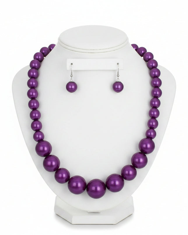 Women's Pearl Necklace Set. Single Strand Purple Acrylic Pearl Graduated Necklace. Neckline Pearls Measures 15.5 mm. Center Pearls Measure 30 mm. Chunky Bubblegum Pearls. Silver Metal Lobster Clasp Closure. Includes Matching Fish Hook Double Pearl Drop Earrings.