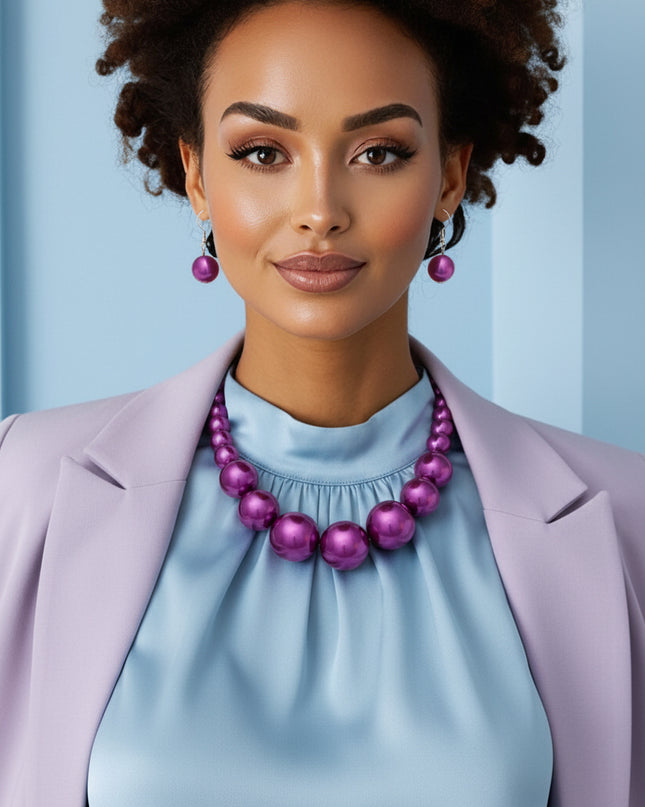 Women's Pearl Necklace Set. Single Strand Purple Acrylic Pearl Graduated Necklace. Neckline Pearls Measures 15.5 mm. Center Pearls Measure 30 mm. Chunky Bubblegum Pearls. Silver Metal Lobster Clasp Closure. Includes Matching Fish Hook Double Pearl Drop Earrings.