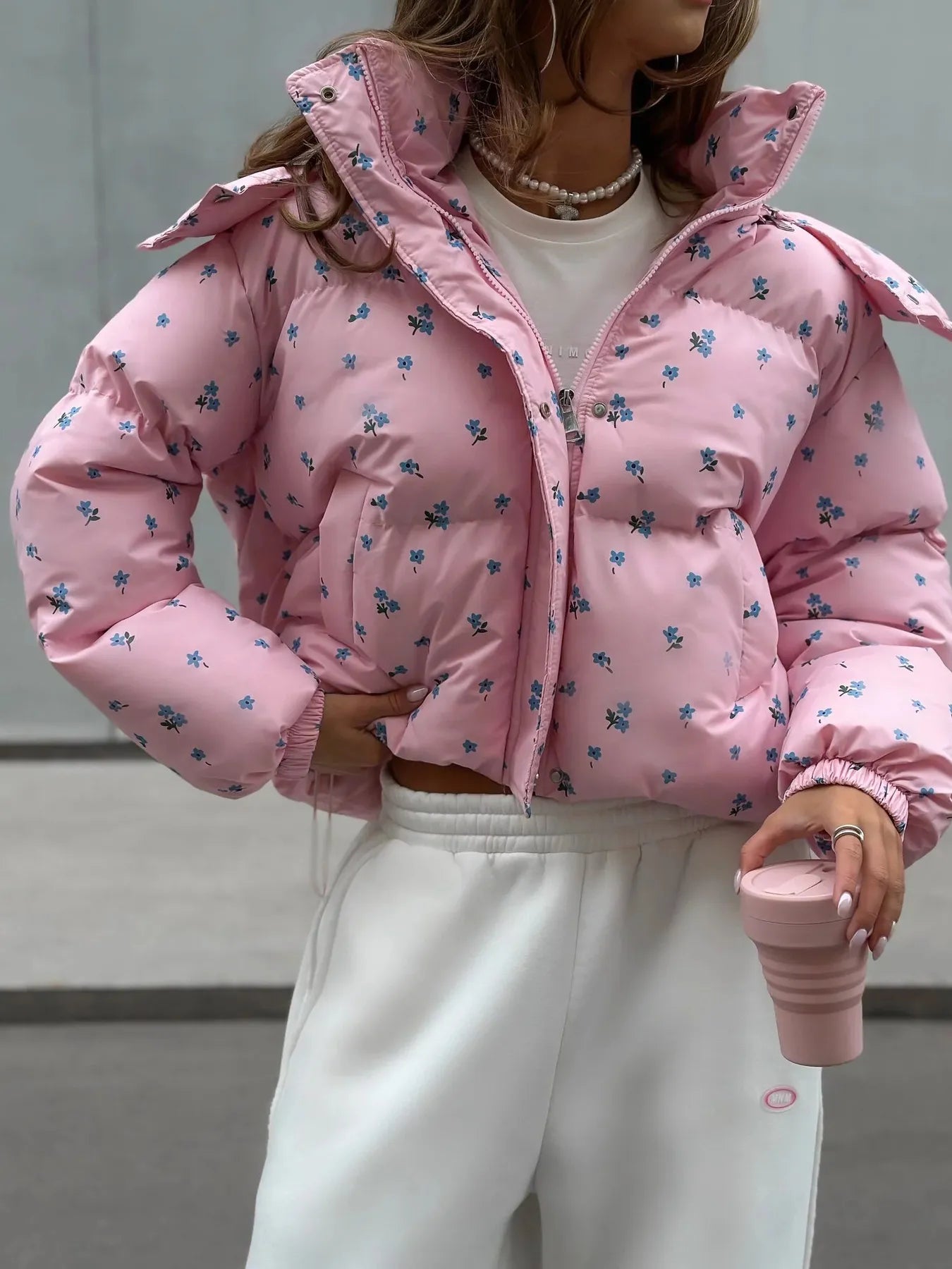 Pink puffer jacket with floral patterns 