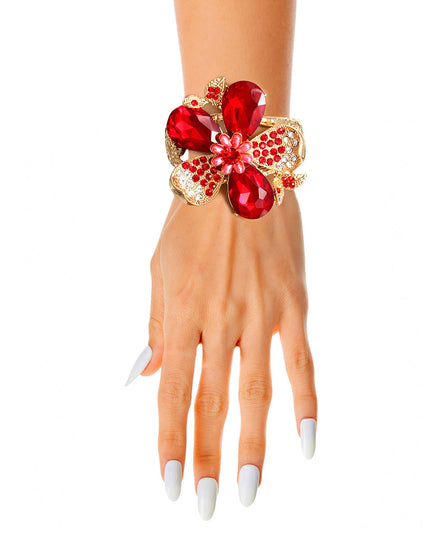 Gold Textured Metal Hinge Closure Cuff Bracelet Featuring Red Teardrop Crystal Rhinestone Flower and Leaves Detailing. Detail measures 2.75 inches. 
