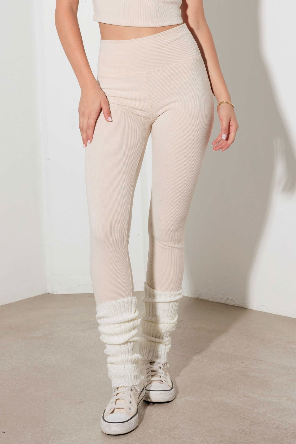 The Ribbed Crop Cami and High Waist Brushed Leggings set features a stylish design with contrast binding and spaghetti straps on the crop Cami top. The ribbed texture adds a trendy touch to the ensemble, making it ideal for activewear. The crop length Cami and high waist brushed leggings provide a snug and comfortable fit, perfect for workouts or yoga sessions. The stretchy and cool fabric ensures flexibility and breathability, making it the perfect attire for a workout or a comfy yet chic yoga look. 