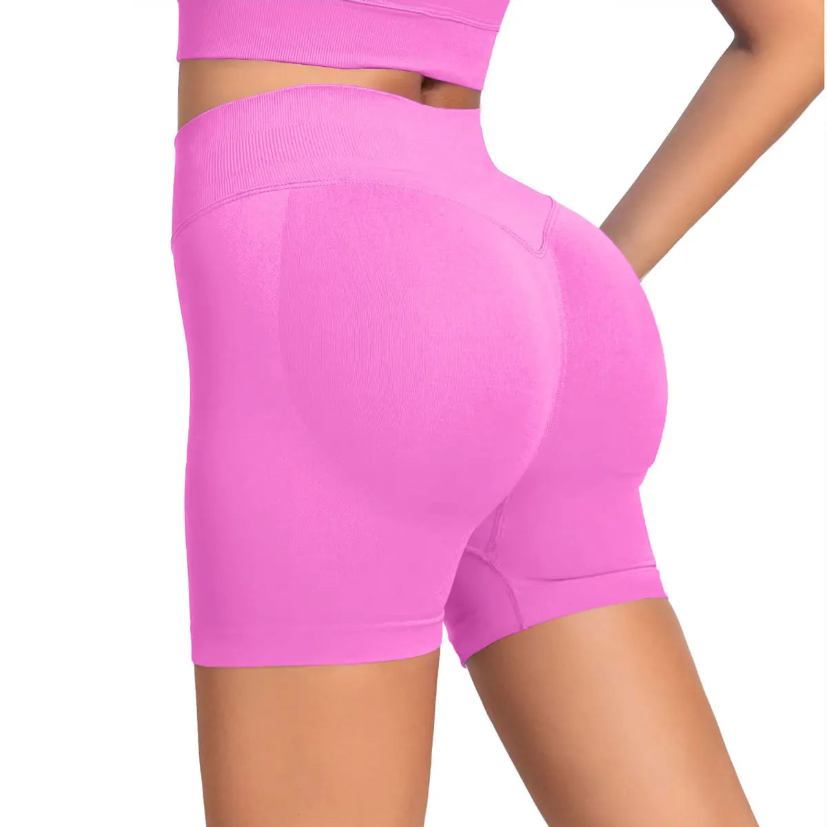 She's wearing pink high-waisted seamless 4.5" gym shorts and a black top.