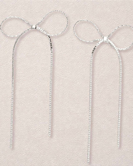 Women's Dangle Earrings. Simple Elegance Silver Metal Ribbon Bow Shaped Earrings Featuring Long Drop Detail. Post Backing.