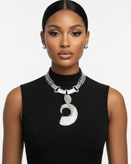 Women's Pendant Necklace Set. Edgy Oversized Chunky Silhouette Pendant Collar Necklace Featuring Hammered Silver Melted Metal Texture Linked Plate Collar with Large Dimensional Open C Chunky Pendant Suspended from Two Double Link Chains. Plate Collar Measures .75 inches Wide. Pendant Measures 4.75 inches x 2.75 inches. Lobster Clasp Closure. Includes Domed Post Backing Stud Earrings.