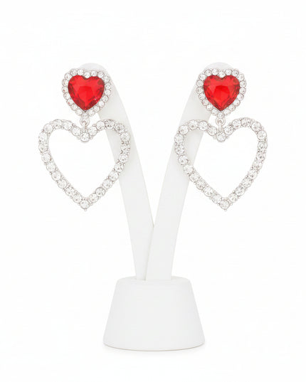 A radiant pair of silver‑tone heart earrings accented with bold red crystal inlays and delicate cutout detailing. 