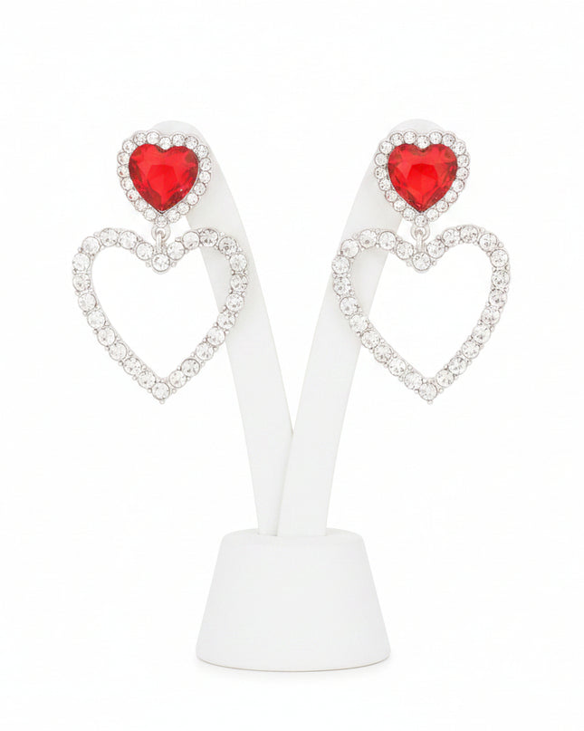 A radiant pair of silver‑tone heart earrings accented with bold red crystal inlays and delicate cutout detailing. 