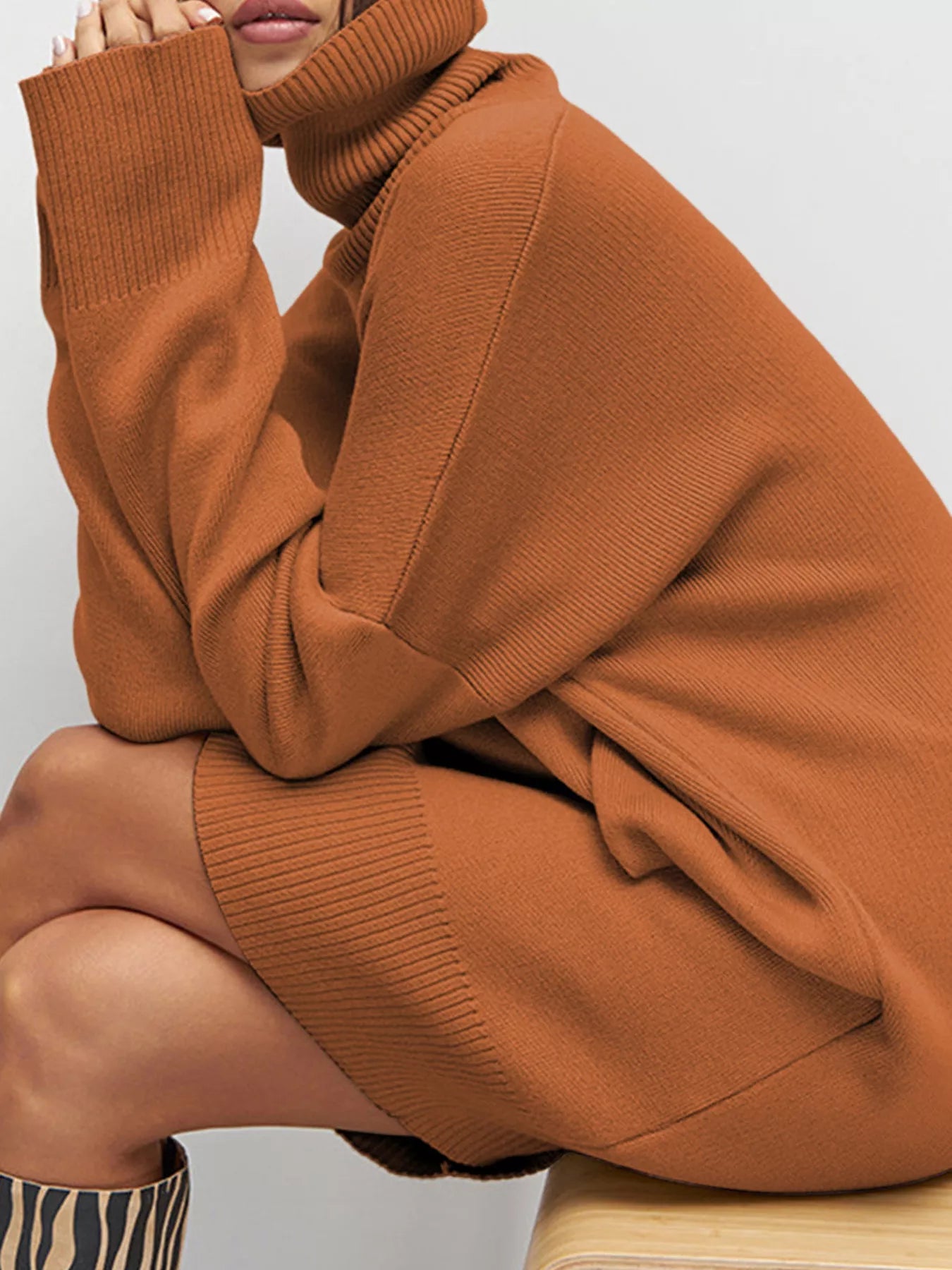 A brown turtleneck sweater dress