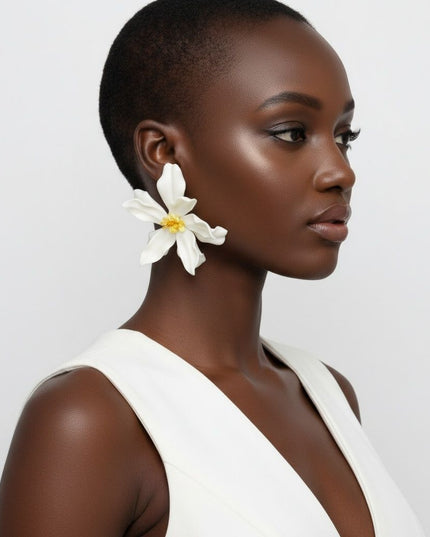 Women's Stud Earrings. Floral Statement Oversized Stud Earrings Featuring Large Dimensional Wavy Acrylic Petals in Dreamy Cream with an Orange and Yellow Beaded Center. Bold and Eye-Catching Floral Playful Elegance. Earrings measure 4.25 inches and 2.25 inches Tall. Post Backing.