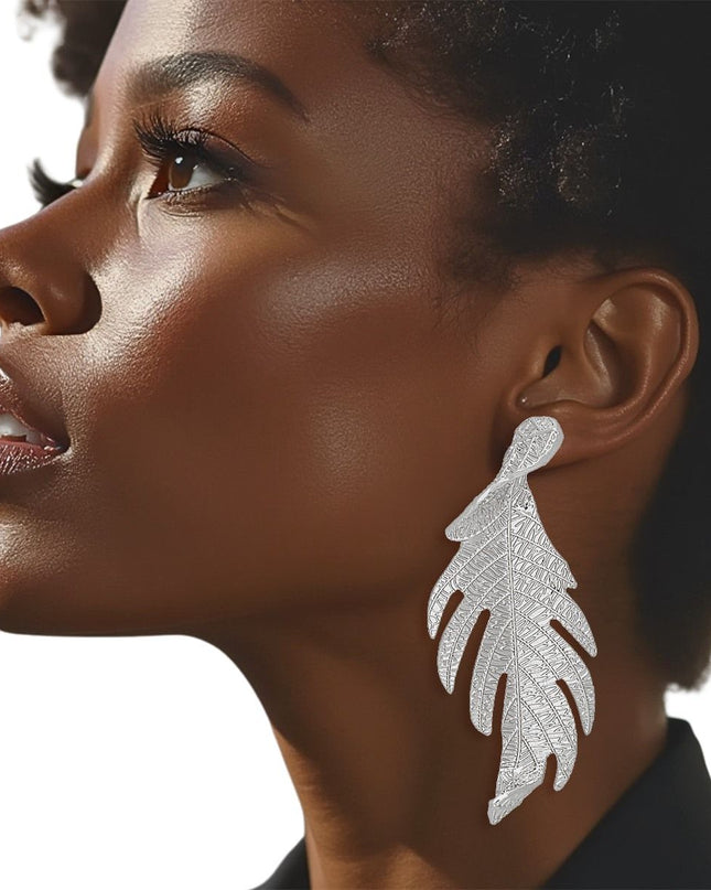 Women's Long Stud Earrings. Modern Botanical Twisted Leaf Elongated Silver Metal Earrings Featuring Natural Textured Detailing. 