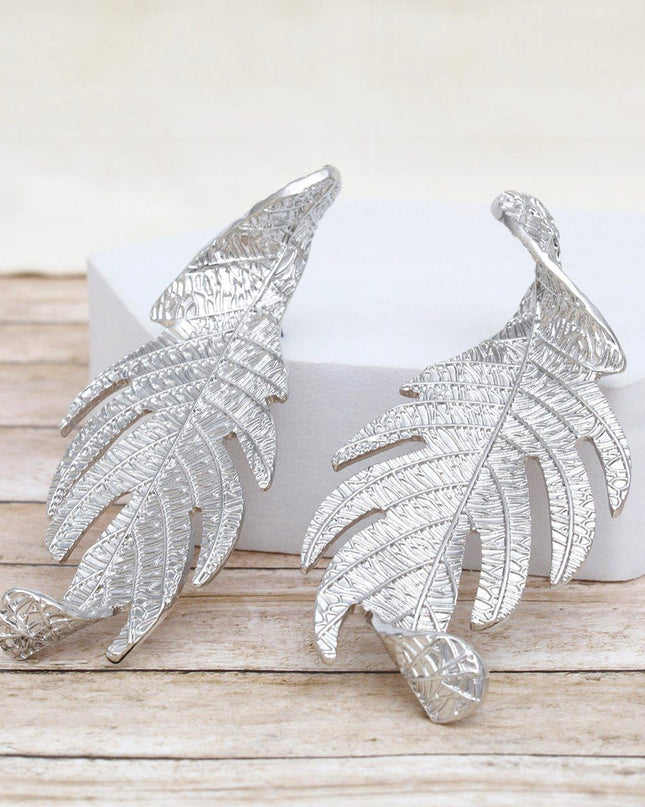 Women's Long Stud Earrings. Modern Botanical Twisted Leaf Elongated Silver Metal Earrings Featuring Natural Textured Detailing. 