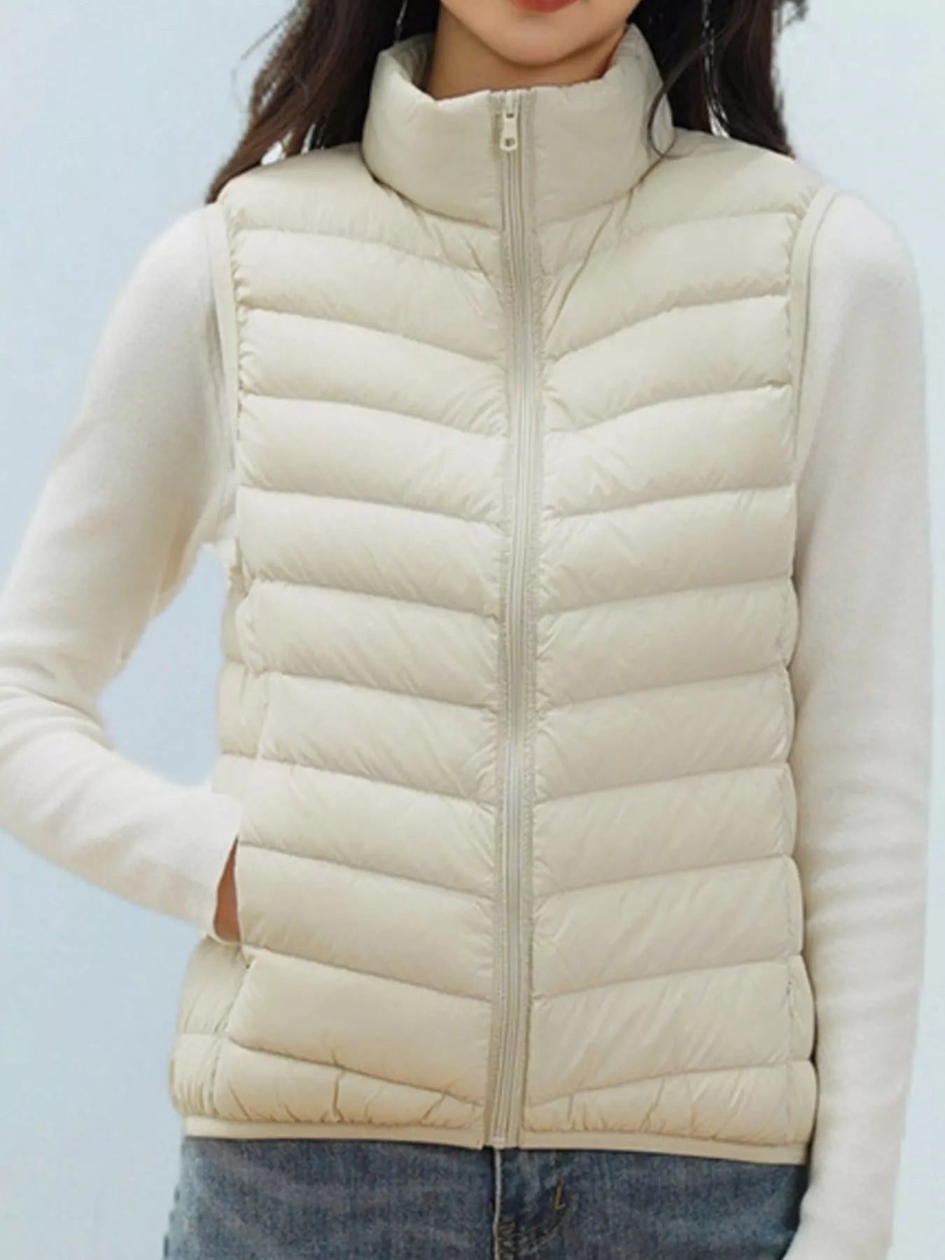 Ivory puffer jacket on a wooden hanger