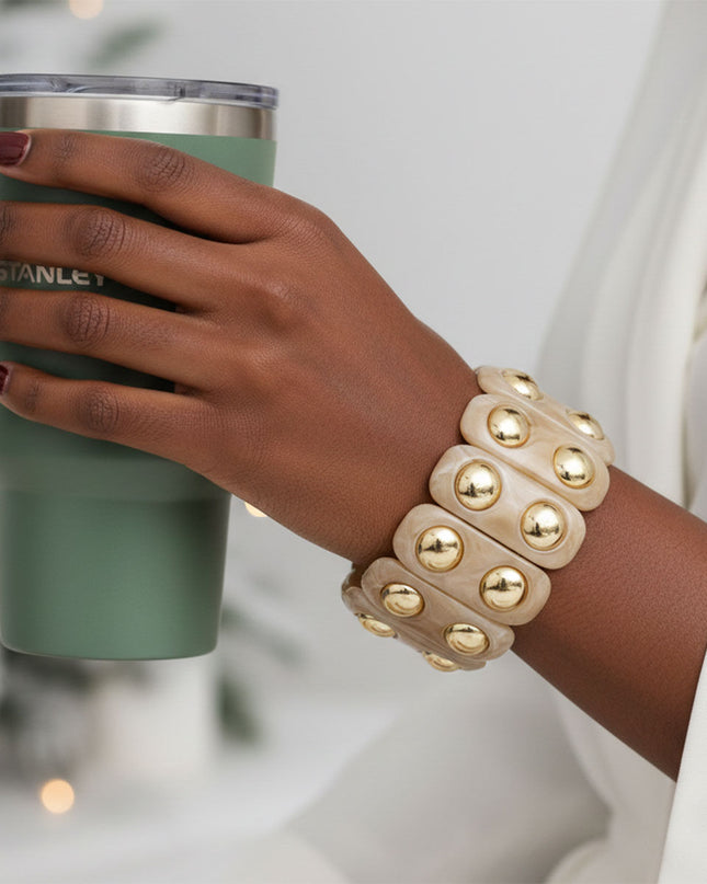 Women's Stretch Cuff Bracelet. Vintage-Style Artistic Marbled Beige Resin Long Oval Disc Stretch Bracelet Featuring Round Gold Stud Detailing. Bracelet Measures 2 inches wide. Neutral Natural Beauties Perfect for Stacking and Layering!