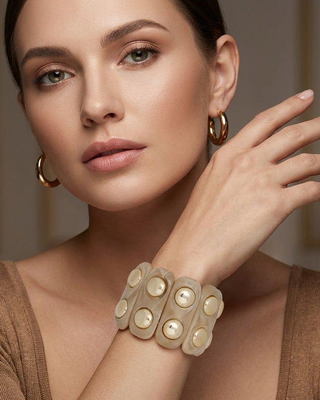 Women's Stretch Cuff Bracelet. Vintage-Style Artistic Marbled Beige Resin Long Oval Disc Stretch Bracelet Featuring Round Gold Stud Detailing. Bracelet Measures 2 inches wide. Neutral Natural Beauties Perfect for Stacking and Layering!