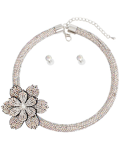 Women's Choker Necklace Set Bling Aurora Borealis Rhinestone Coated Rigid Tube Choker Featuring Elegant Layered Flower Rhinestone Offset Detail. Silver Metal Lobster Clasp Closure. Black Felt Backing on Flowers. Flower measures 2.5". Includes Matching Rhinestone Stud Post Earrings.