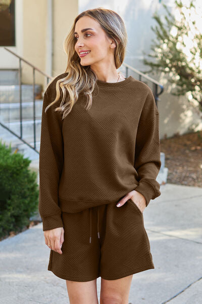 Designed with a stylish textured fabric, this full-size set features a long sleeve top and matching drawstring shorts, making it the perfect outfit for lounging, casual outings, or running errands.

Top Features:

Relaxed fit with a drop-shoulder silhouette for a laid-back vibe

Textured knit fabric adds subtle dimension and interest

Crew neckline for a classic, clean look

Long sleeves with cuffed hems to keep the chill away

Slightly tunic-length hem—great for wearing tucked or untucked